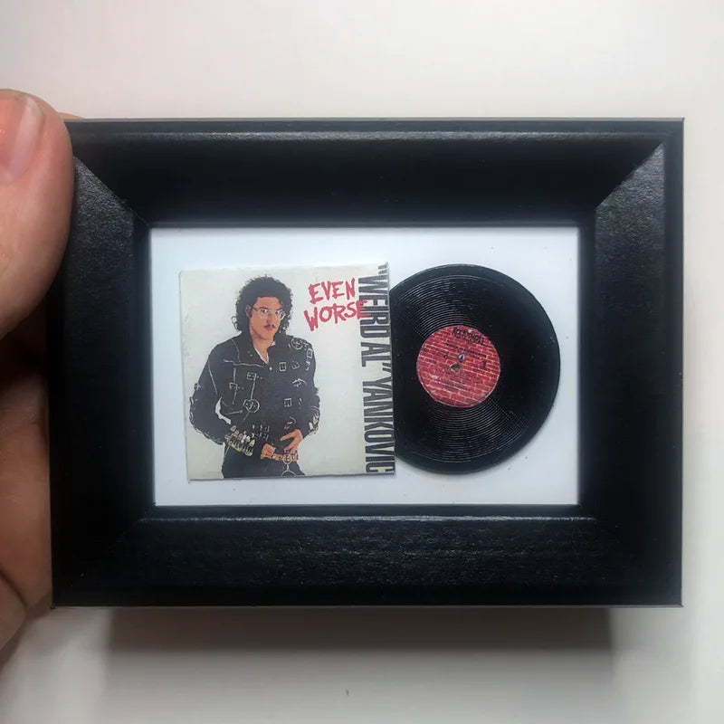Hand holding a miniature framed Michael Jackson vinyl album display by Rodger Beck