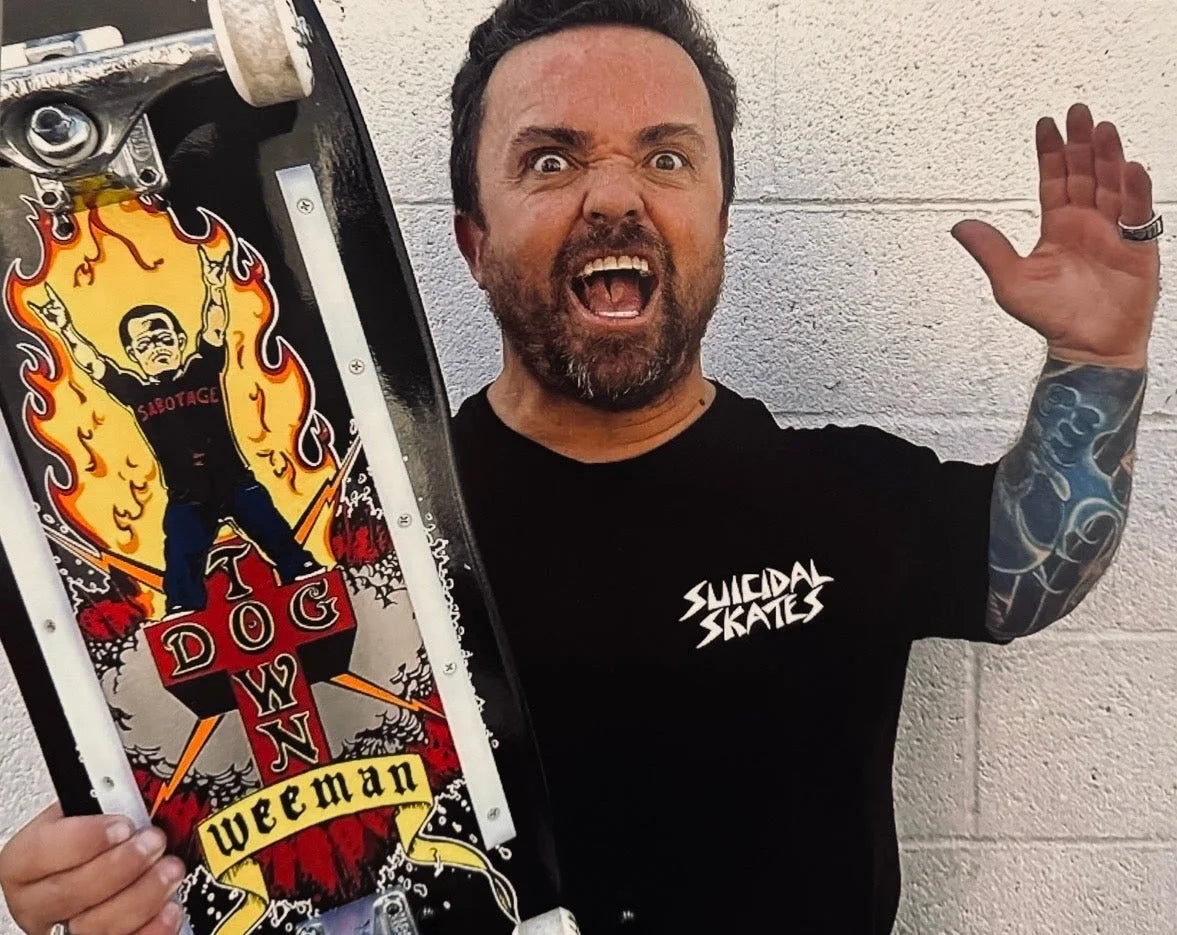 Jason Wee Man Acuña holding his Dogtown skateboard